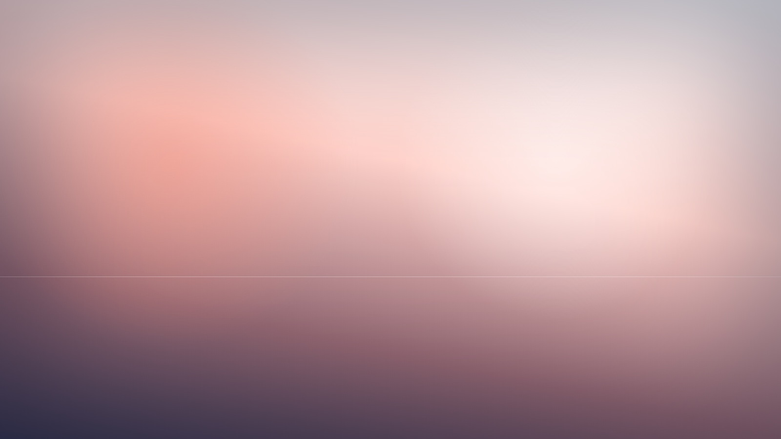 A calm open field of gentle colour under a steady, quiet light.